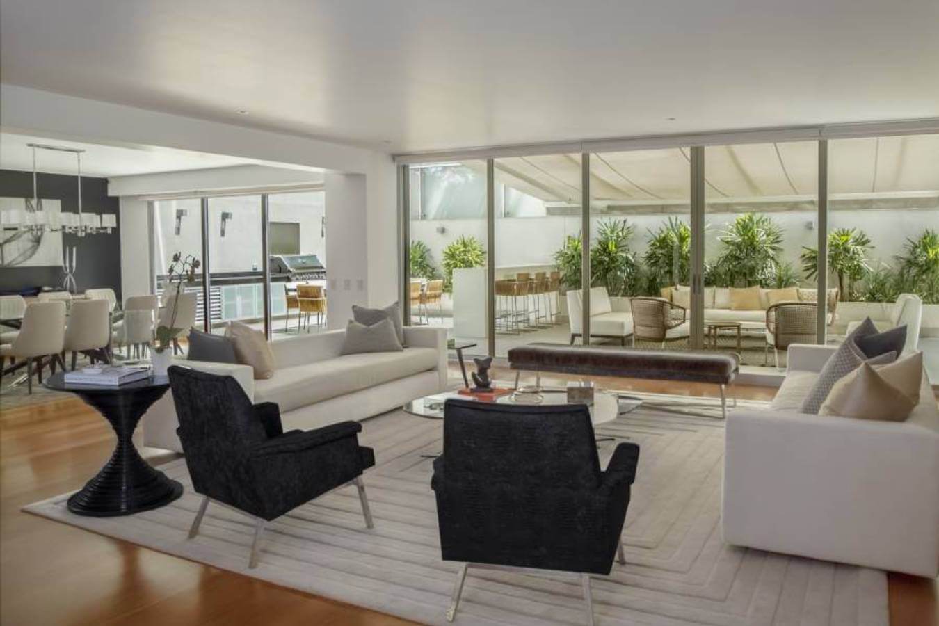 Professional recurring cleaning by Mkleaning in a beautifully maintained high-end living room with large glass doors leading to the outdoor area in Brookhaven.