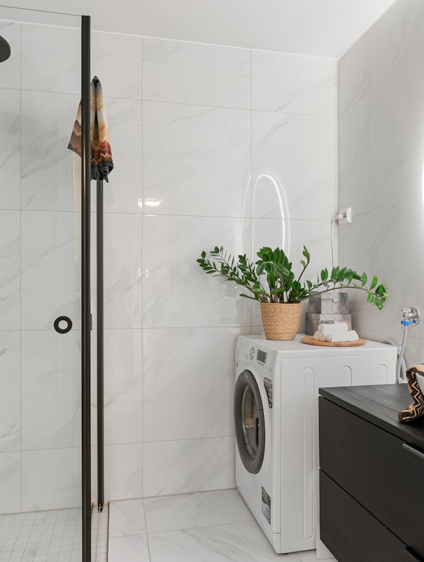 Professional recurring cleaning by Mkleaning in a beautifully maintained high-end bathroom with washer and shower in Dunwoody.