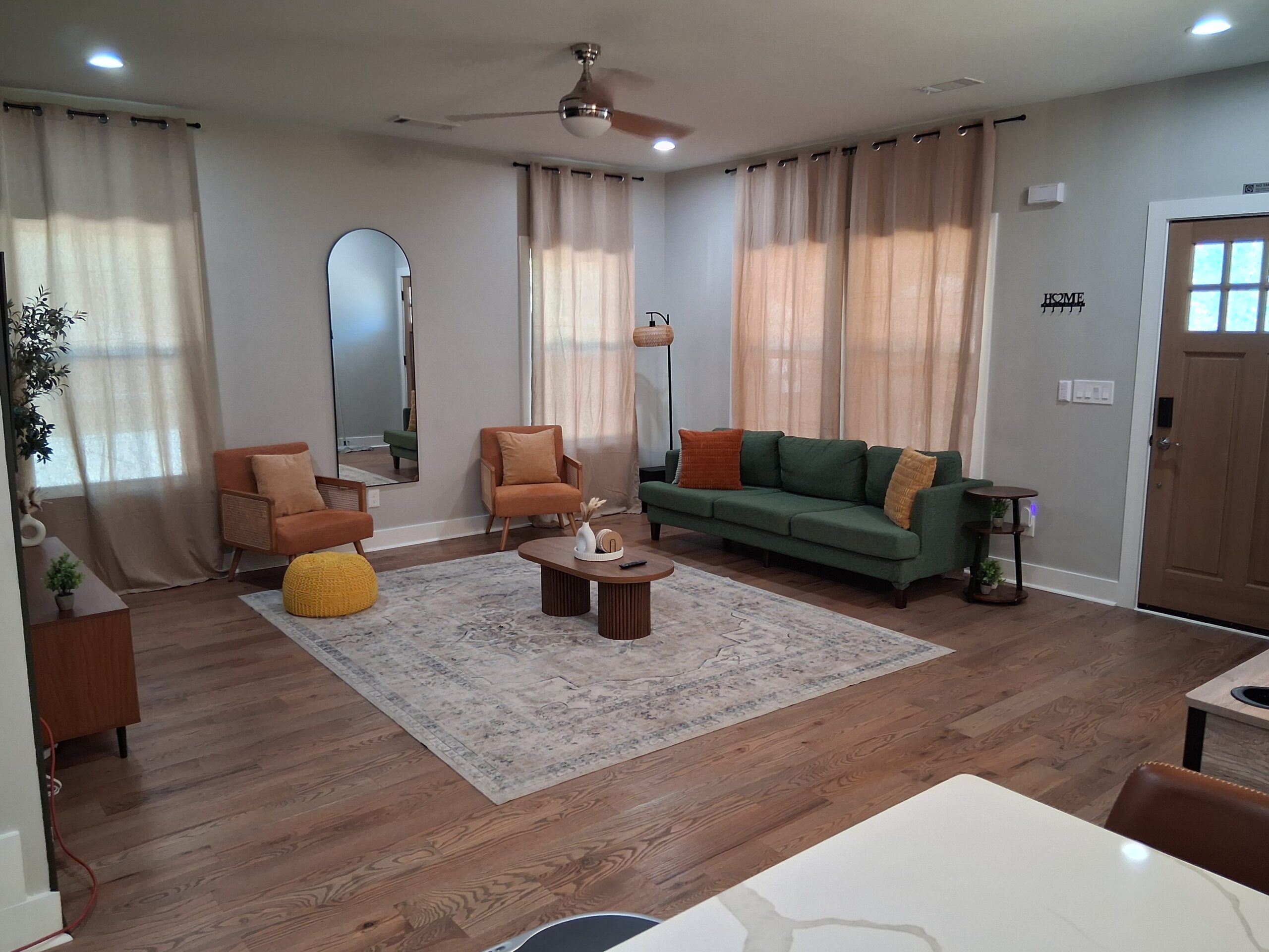 A beautifully decorated living room in Alpharetta, professionally cleaned and prepared by Mkleaning, showing a spotless carpet and tidy arrangement to make clients feel at home.