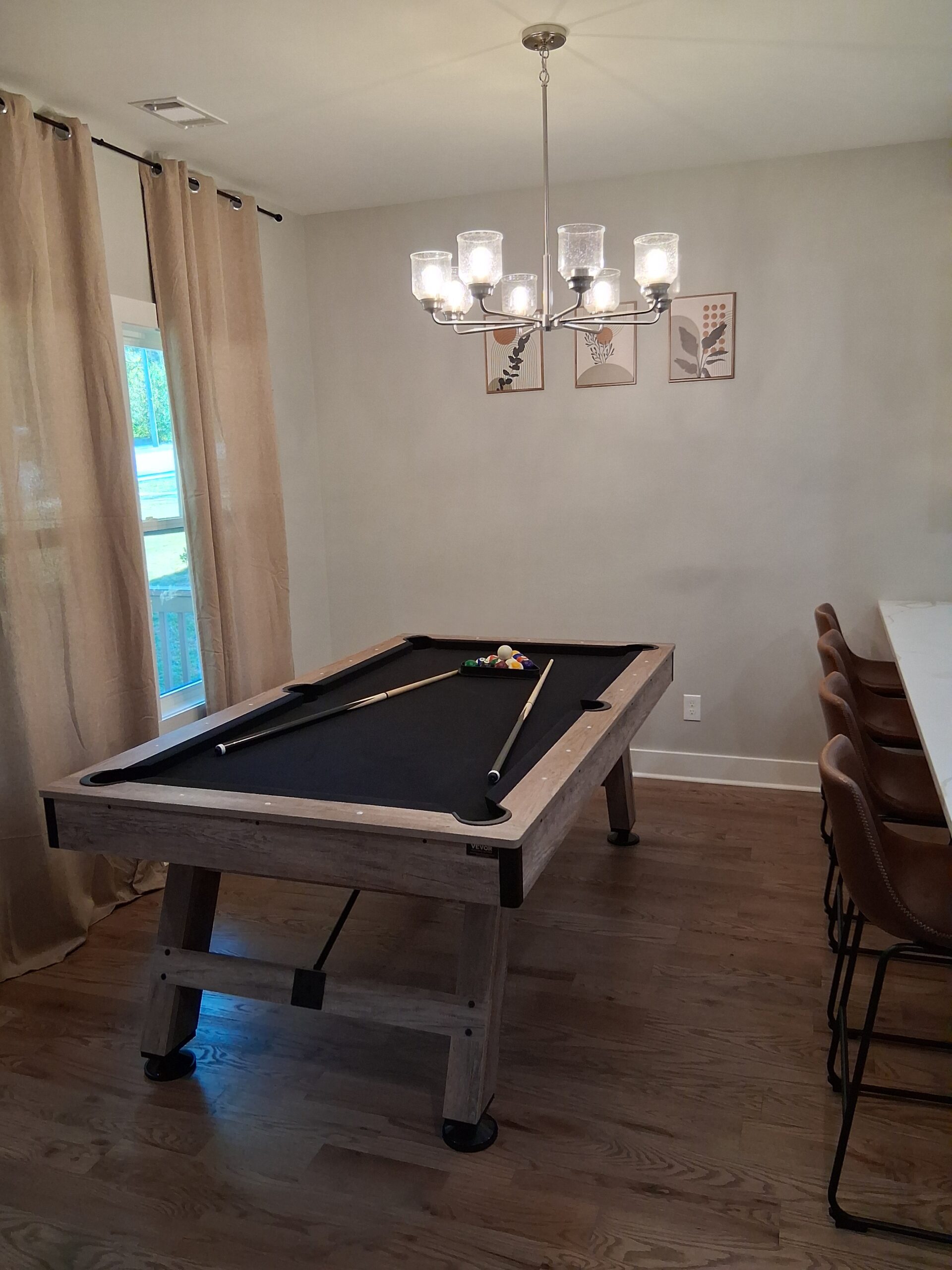 A beautifully maintained game room in Alpharetta, featuring a billiard table with velvet surface, professionally vacuumed and cleaned by Mkleaning to ensure every detail is spotless.