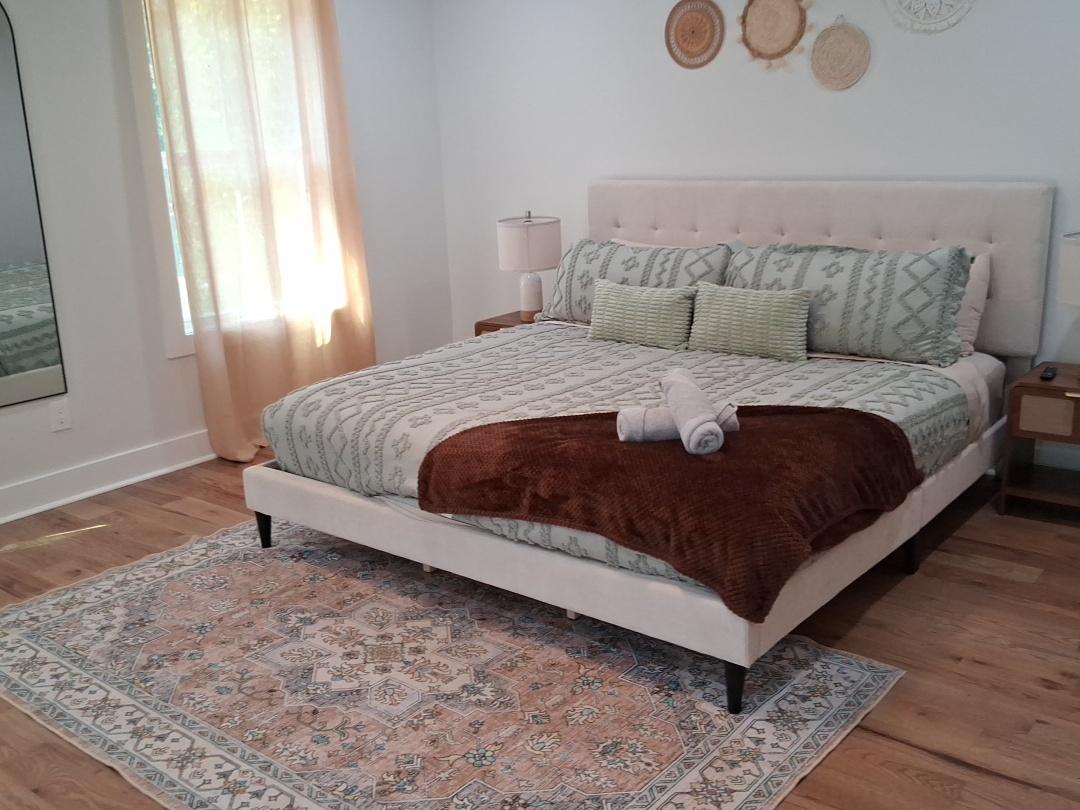 Professional recurring cleaning by Mkleaning in a beautifully maintained high-end bedroom with neatly made bed and attention to details in Smyrna.