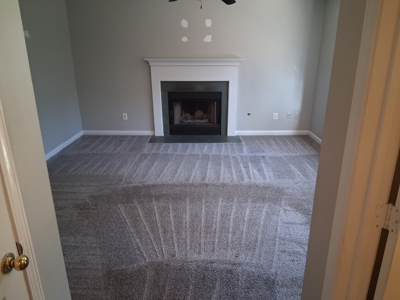 Professional carpet cleaning by Mkleaning in Smyrna, showing a living room carpet thoroughly vacuumed to remove debris before deep carpet shampoo washing.
