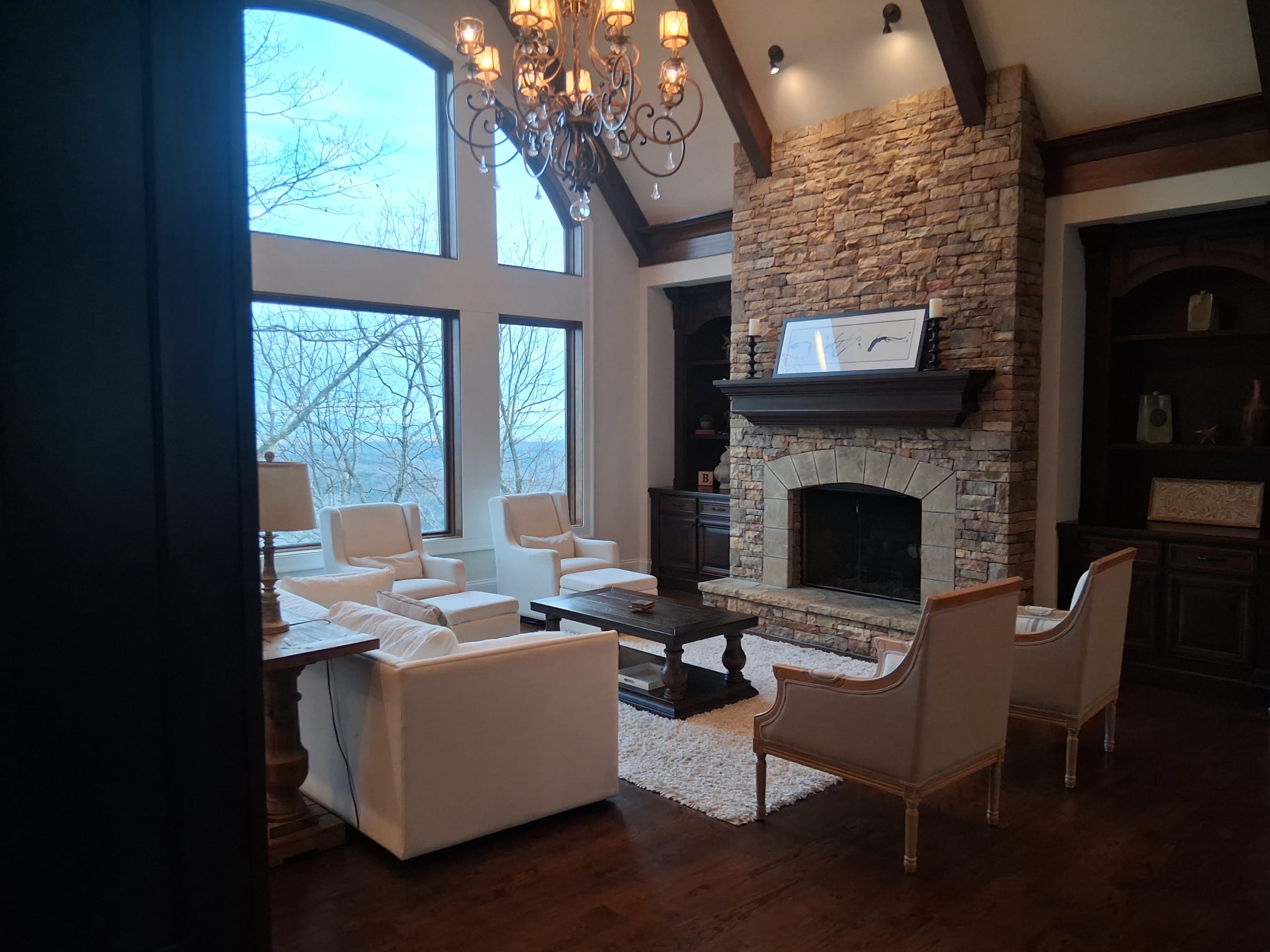 Deep cleaning of a living room with detailed care for floors, furniture surfaces, fireplace area, and natural light entry