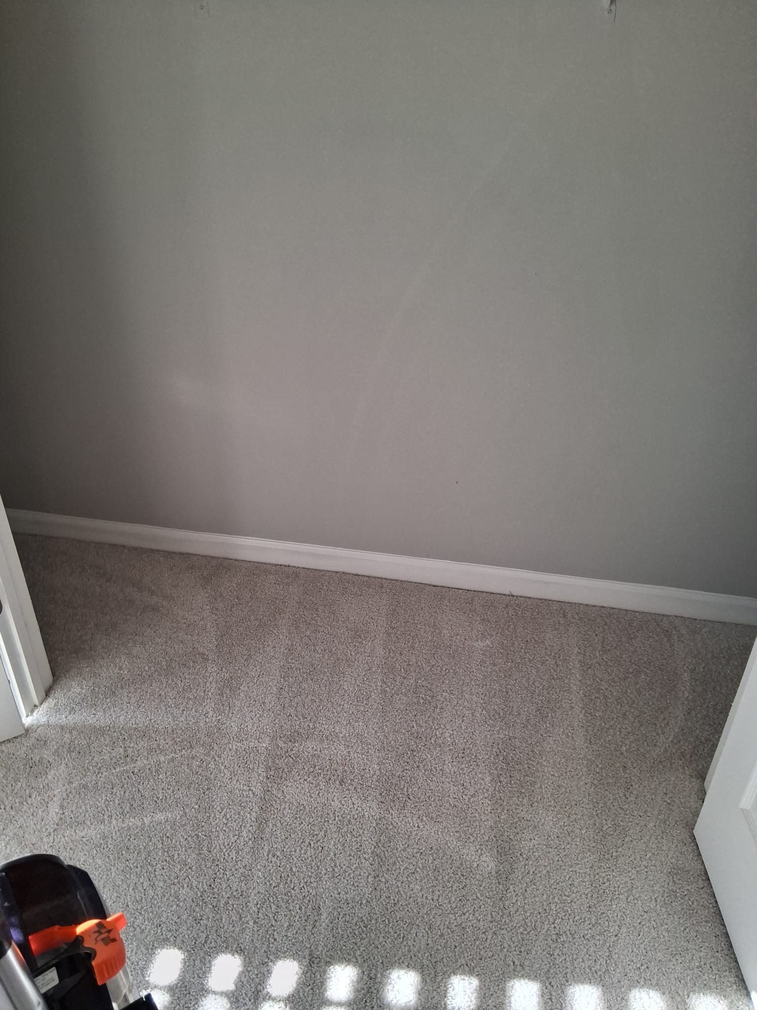 Professional carpet shampoo cleaning in a small residential closet for deep dirt removal and fresh results