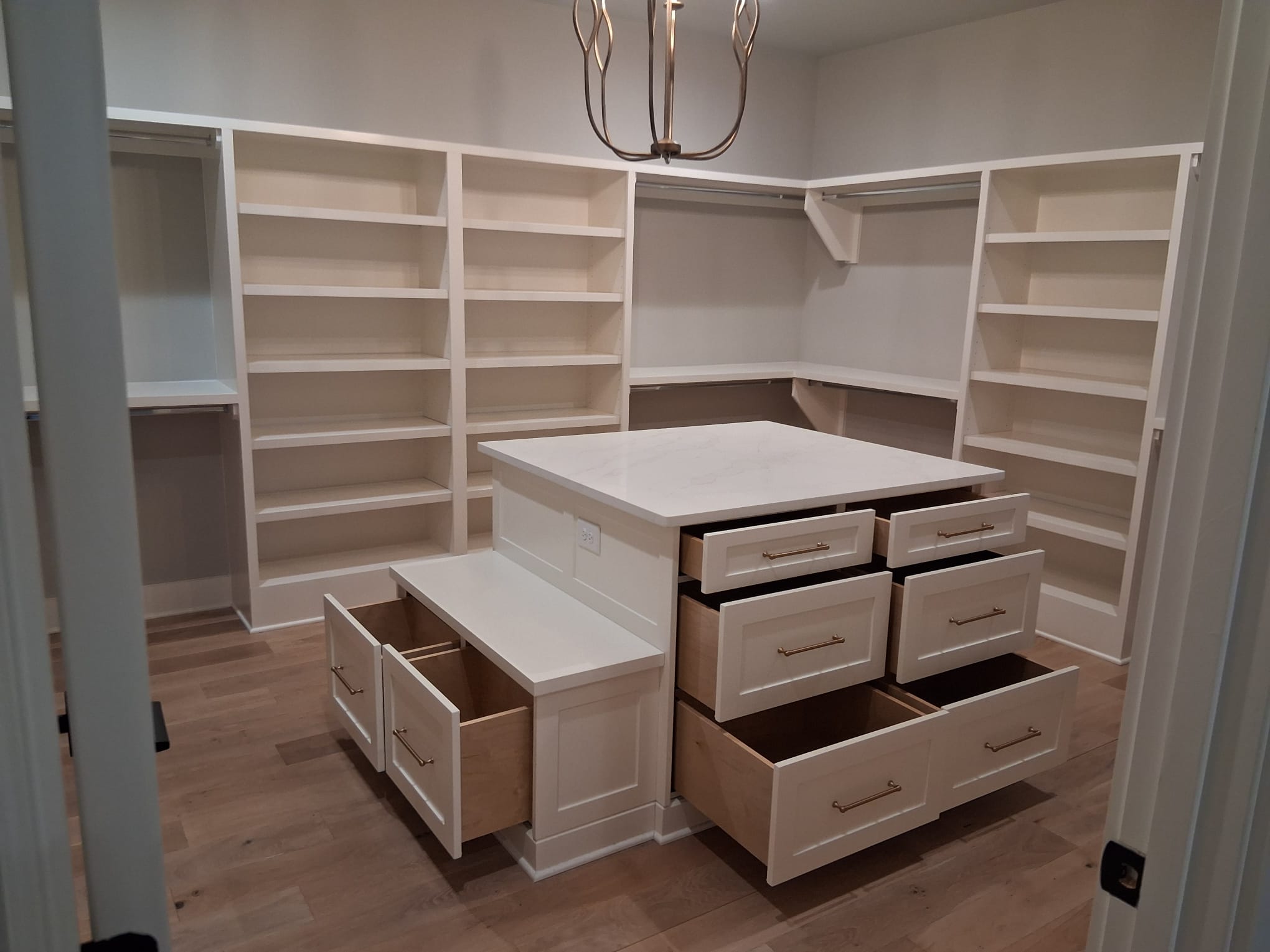 Professional move-out cleaning of a master closet with cleaned shelves, drawers, and interior cabinets
