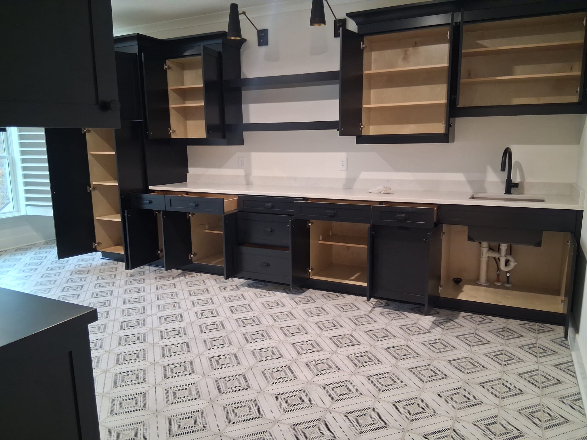 Move-out cleaning of laundry room with detailed cabinet, floor, and appliance area cleaning