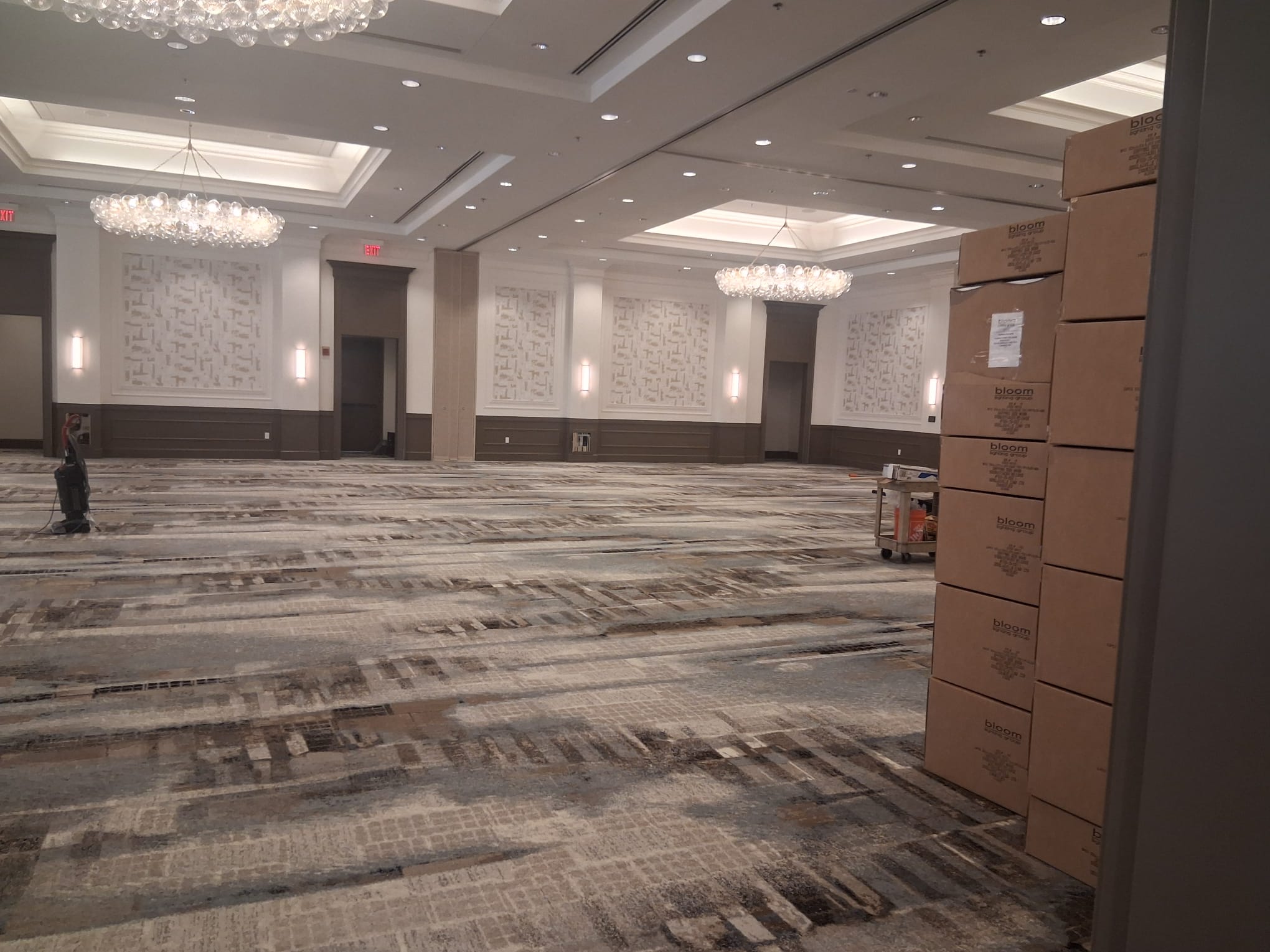 Regular cleaning of a large conference hall with carpeted floors and organized open space in a commercial building