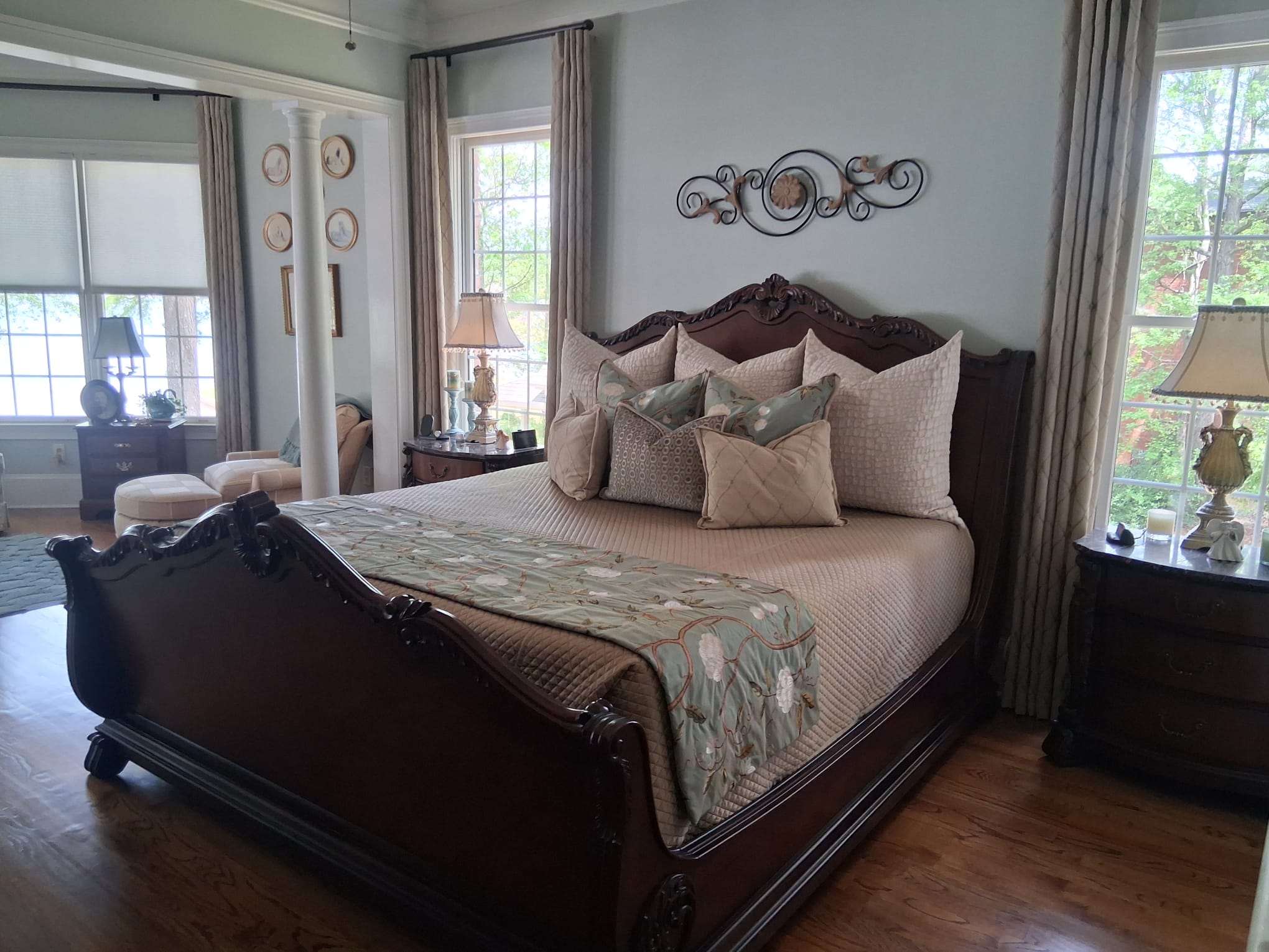 Regular bedroom cleaning with bed, furniture, hardwood floors, and large windows in Atlanta GA